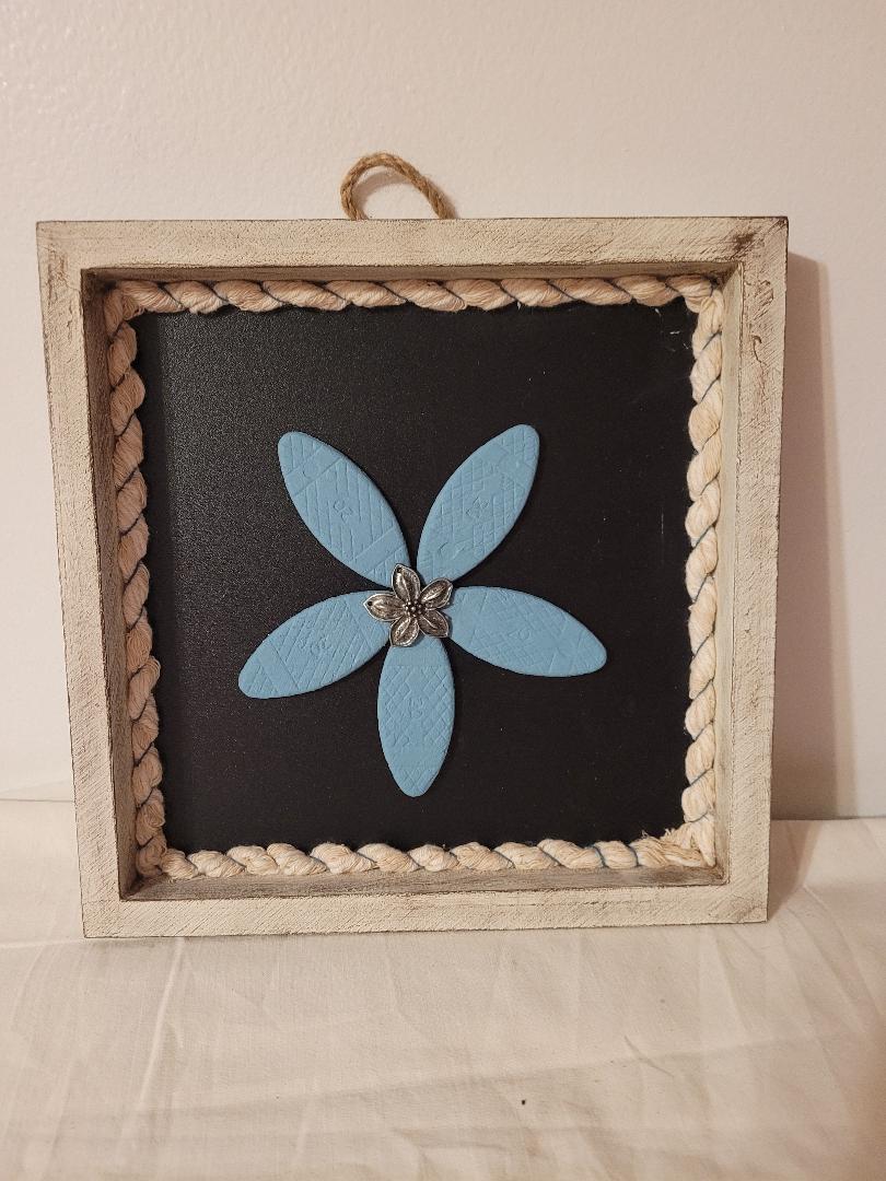wooden blue flower in frame
