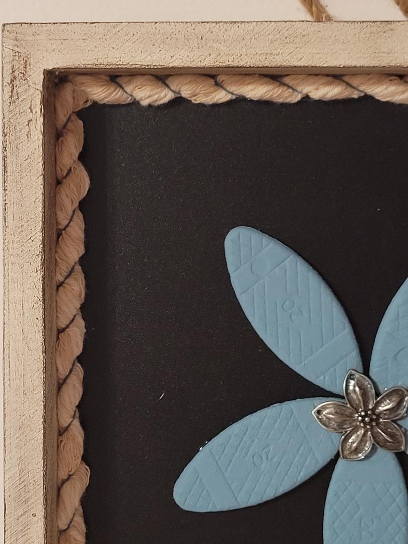 wooden blue flower in frame