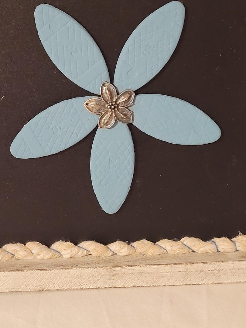 wooden blue flower in frame